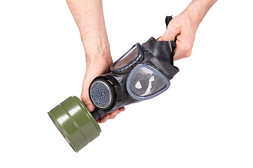 Image showing Man holding vintage gasmask isolated on white - Green filter