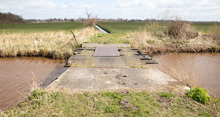 Image showing Old concrete and wooden crumbling bridge 