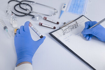 Image showing Analyst hands holding Coronavirus COVID 19 test blood making sta