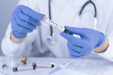 Image showing Doctor hands holding COVID 19 Coronavirus test blood
