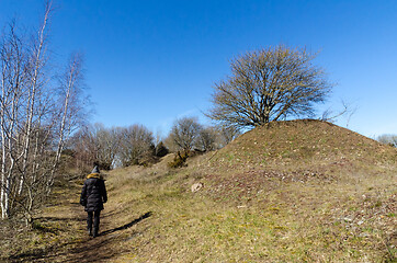 Image showing Woman walks on a footpath in spring season