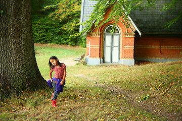 Image showing Portrait of a young cute girl looking at the camera outdoor