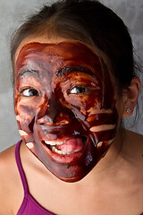 Image showing young asian girl having fun with a chocolate mask