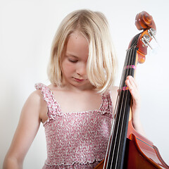 Image showing Portrait of a young teenager girl in studio with a cello