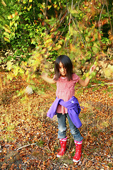 Image showing Portrait of a young cute girl looking at the camera outdoor