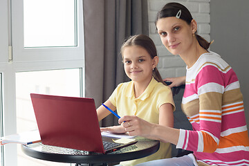 Image showing Girl and mother undergo interactive online education at home