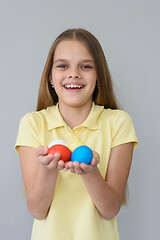 Image showing Portrait of a girl with Easter eggs on a gray background
