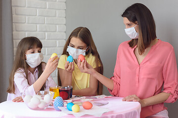 Image showing Mom and two quarantined daughters painted eggs for Easter