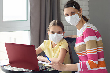 Image showing Mom and daughter do their homework in self-isolation mode through online services