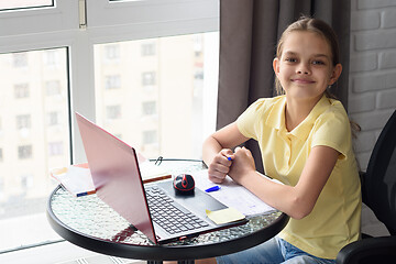 Image showing Joyful girl did homework looked in frame