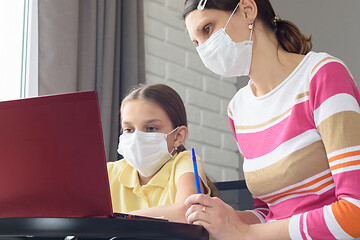 Image showing Girl and tutor in medical masks study remotely online