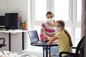 Image showing Mom and quarantined daughter study in self-isolation mode without leaving home