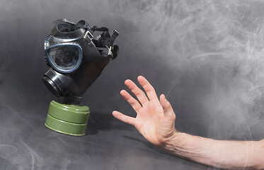 Image showing Man in room filled with smoke, trying to reach for vintage gasma