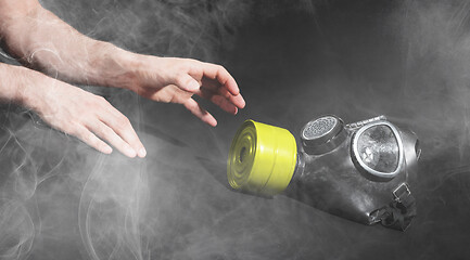 Image showing Man in room filled with smoke, trying to reach for vintage gasma