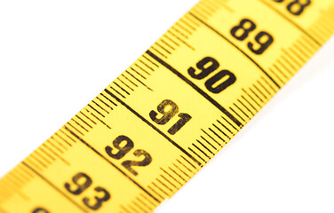 Image showing Close-up of a yellow measuring tape isolated on white - 91