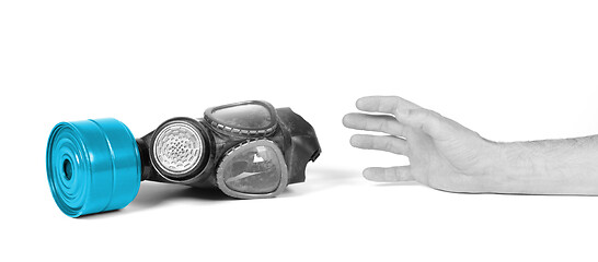 Image showing Arm reaching for vintage gasmask isolated on white - Blue filter