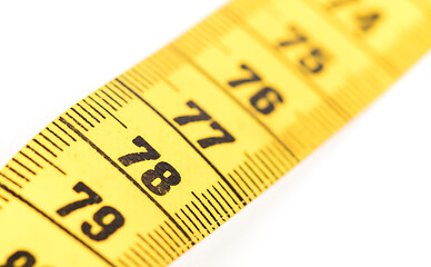 Image showing Close-up of a yellow measuring tape isolated on white - 78