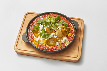 Image showing Pan with homemade traditional Shakshuka dish with spicy sauce from tomatoes.