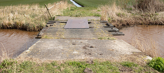 Image showing Old concrete and wooden crumbling bridge 