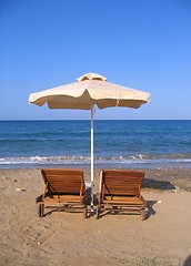 Image showing Beach chairs and umbrella