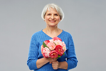 Image showing happy smiling senior woman with flowers