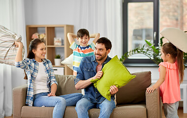 Image showing happy family having pillow fight at home