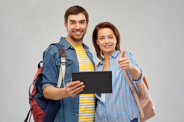 Image showing happy couple of tourists with tablet computer