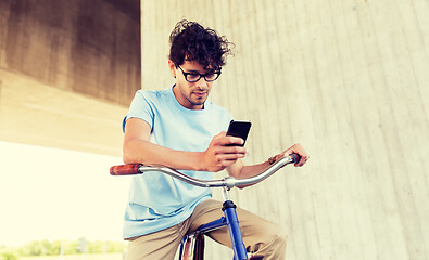 Image showing man with smartphone and fixed gear bike on street