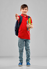 Image showing student boy with books and bag pointing to you