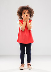 Image showing confused african american girl covering mouth