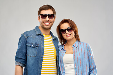 Image showing happy couple in sunglasses over grey background