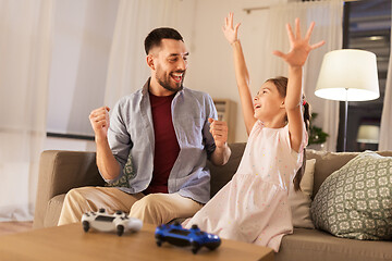 Image showing father and daughter playing video game at home