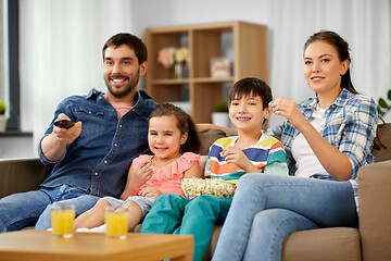 Image showing happy family with popcorn watching tv at home