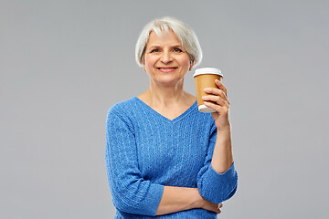 Image showing smiling senior woman with takeaway coffee cup