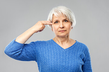 Image showing senior woman making making finger gun gesture