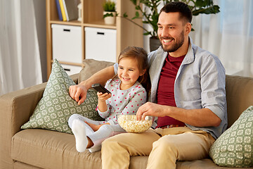 Image showing happy father and daughter watching tv at home