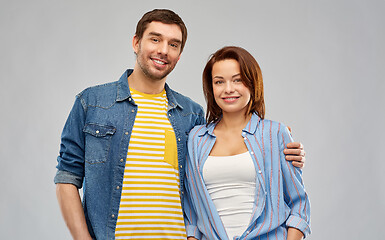 Image showing happy couple hugging over grey background