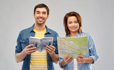 Image showing happy couple of tourists with city guide and map