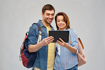 Image showing happy couple of tourists with tablet computer