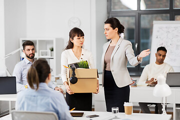 Image showing fired sad female office worker leaving