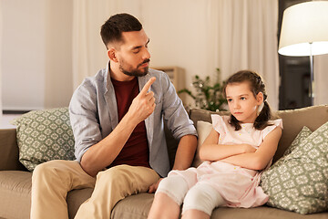 Image showing upset or feeling guilty girl and father at home