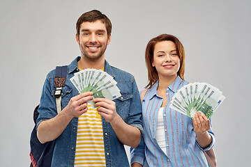 Image showing couple of tourists with backpacks and money