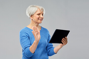 Image showing senior woman having video call on tablet computer