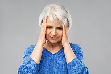 Image showing senior woman suffering from headache