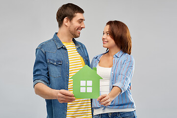 Image showing smiling couple holding green paper house