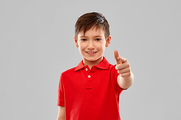 Image showing smiling boy in red t-shirt pointing finger to you