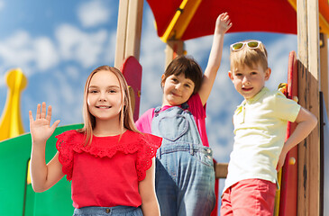 Image showing smiling girl waving hand on kids playground