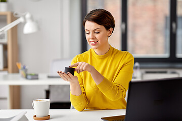 Image showing businesswoman using smart speaker at office