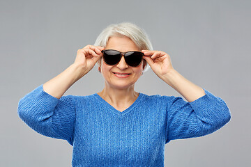 Image showing smiling senior woman in black sunglasses