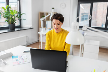 Image showing creative woman working on user interface at office